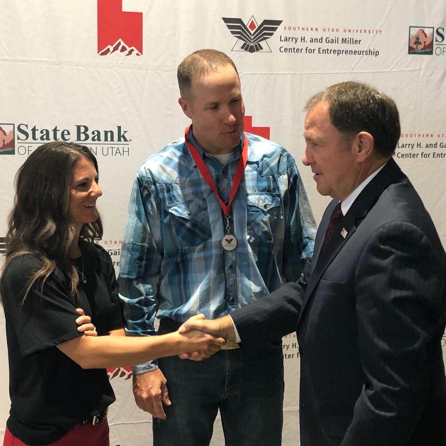 LeeAnn and Mike shake hands with the governor